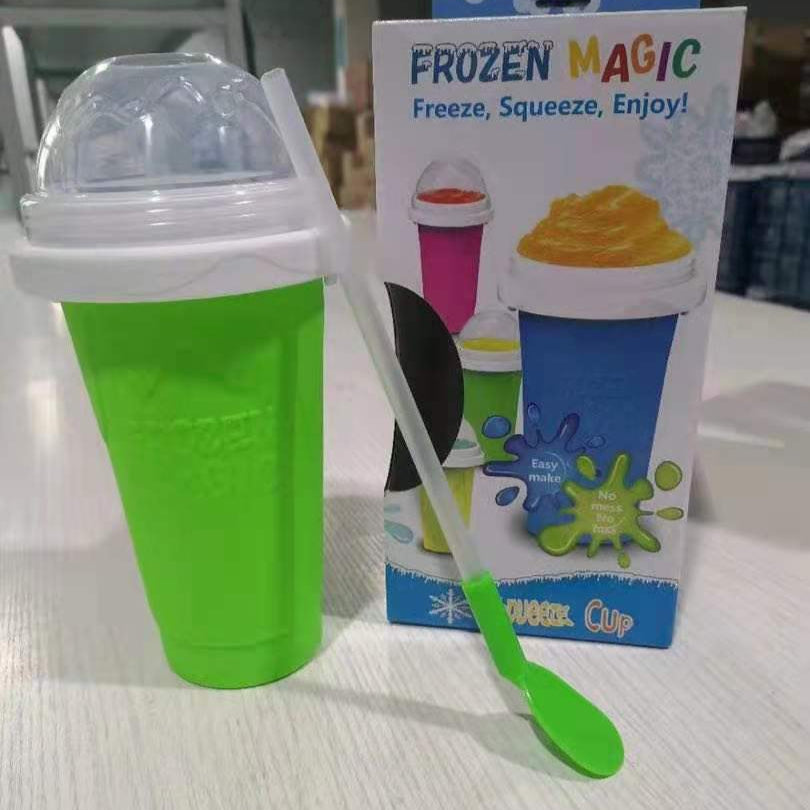 Green Slushy Maker Cup with a spoon and packaging labeled 'Frozen Magic' on a light surface.