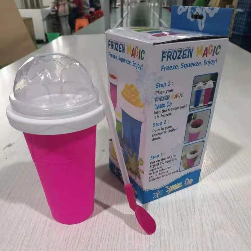 Pink Slushy Maker Cup with a spoon next to its packaging on a white surface